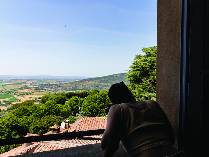 Creative School student looking out the window of St. Augustino Convention Centre, in Cortona where classes are held. 